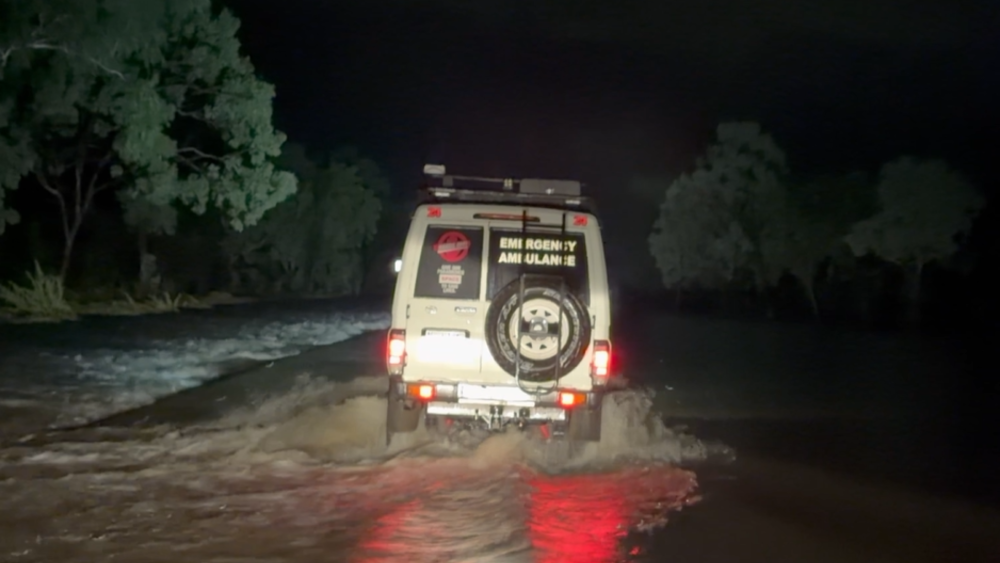 St John NT Troop Carrier Ambulance transporting Anastasia and Venice through floodwaters to the airport.