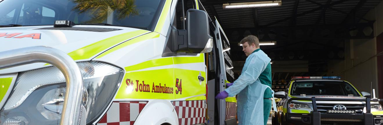 Man looking inside ambulance.