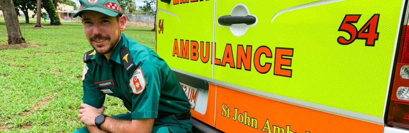 Rhys Dowell sitting behind an ambulance.