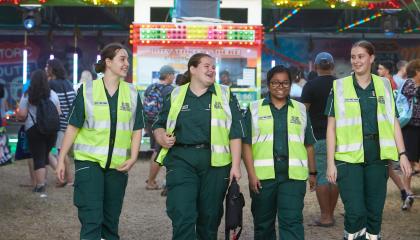 Four St John volunteers walking side by side.