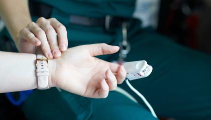 Paramedic measuring patient's heartrate.