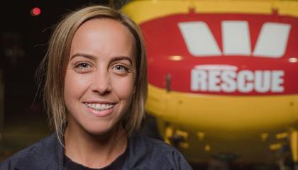Caity in front of a rescue helicopter.