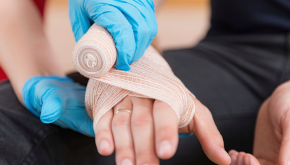 Bandaging a hand.